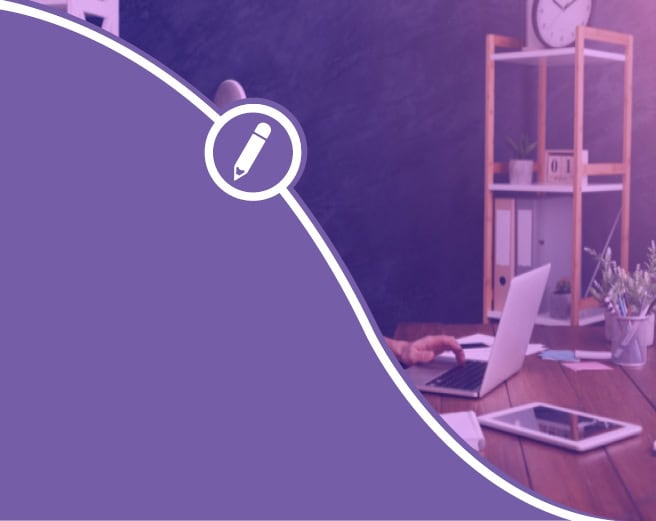 A person sitting at a desk using a laptop