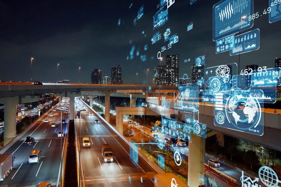 a highway at night with a display of numbers and graphs