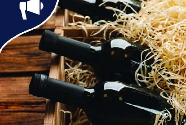 bottles of wine in a wooden box with straw