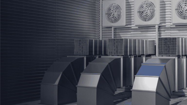 a row of metal ducts with fans on top of them