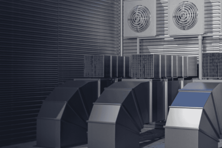 a row of metal ducts with fans on top of them